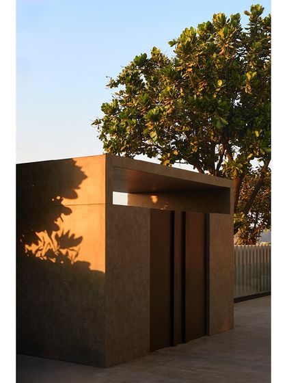 The new ACP-clad portal at sunset, showcasing its strong geometric form and the warm, inviting glow of the exterior lighting.