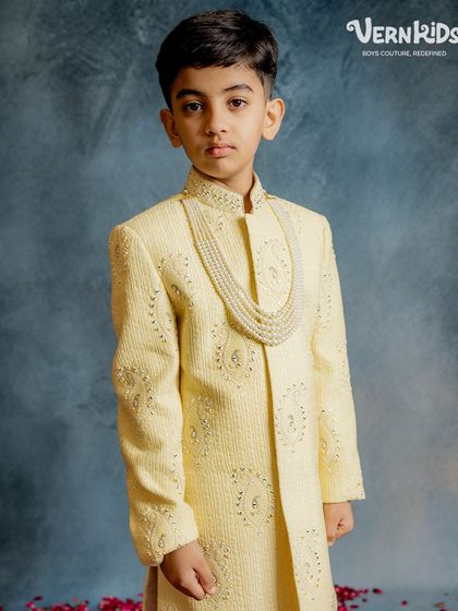 A closer look at our pale yellow sherwani from the Jashn Collection. The intricate embroidery and pearl necklace detail make this a truly special occasion piece for your little one.