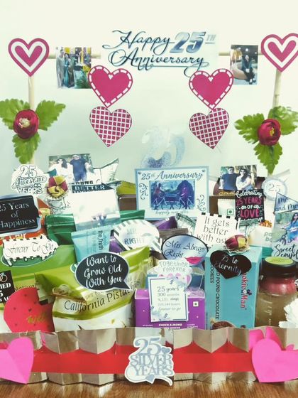 Another take on a 25th silver jubilee anniversary, this hamper is decorated with heart cutouts and photos. It's filled with snacks and treats to celebrate 25 years of happiness.