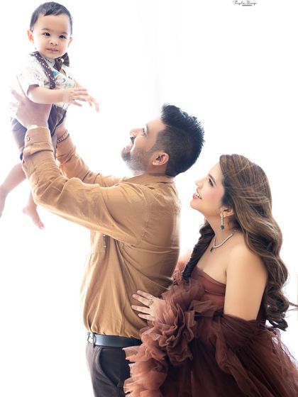 A joyful, high-energy shot of a dad lifting his son into the air. These are the fun, candid moments that truly capture a family's spirit.