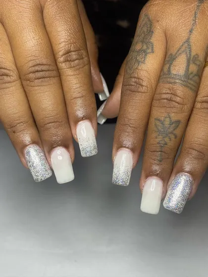 A close-up view showcasing the detail in the holographic glitter and the clean cuticle application on these bridal nail extensions.