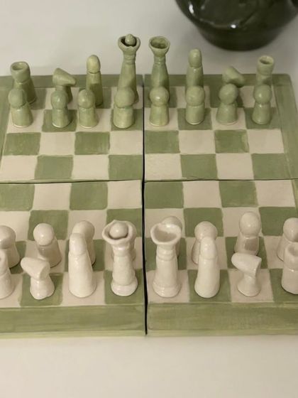 Artist Anitha Balu created these unique pieces, including a full chess set and a clock that fuses resin with a ceramic base, blending traditional and modern methods.