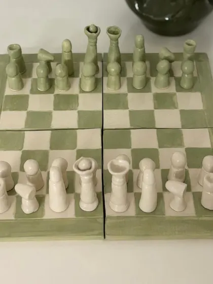 Artist Anitha Balu created these unique pieces, including a full chess set and a clock that fuses resin with a ceramic base, blending traditional and modern methods.