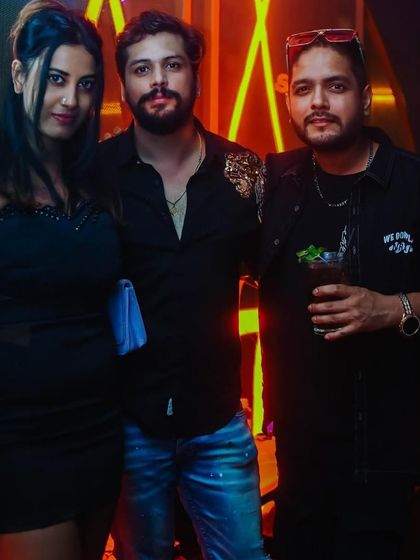 Posing with friends and enjoying the party atmosphere.