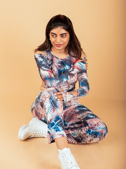 A relaxed, seated pose in a modern outfit. This studio shot is versatile and can be used for fashion, branding, or personal portraits.