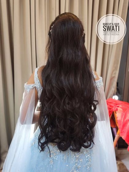 The back view of the stunning long ponytail, perfect for a modern and chic bride.
