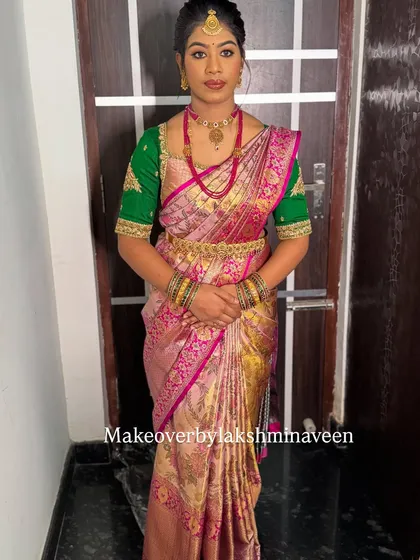 A full-length view of the pink and green half-saree look, showcasing the complete styling from head to toe.