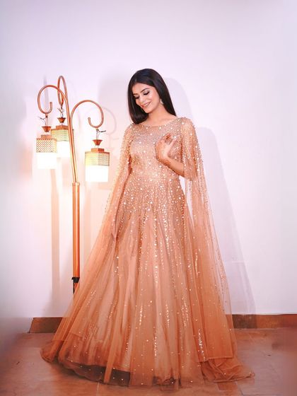 A full-length shot showing the beautiful A-line silhouette and flowing cape.