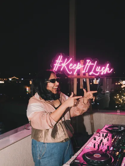 Me in my element at a Lush Loft rooftop party in Delhi. The '#KeepItLush' neon sign says it all. These parties are my creative playground, where I can experiment with sounds and create a truly personal and welcoming atmosphere.