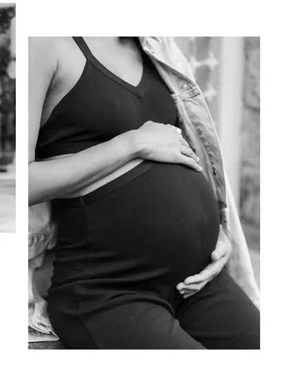 A close-up on the baby bump during our city session. The contrast of the soft denim jacket and the hard stone wall creates a beautiful texture in this black and white shot.