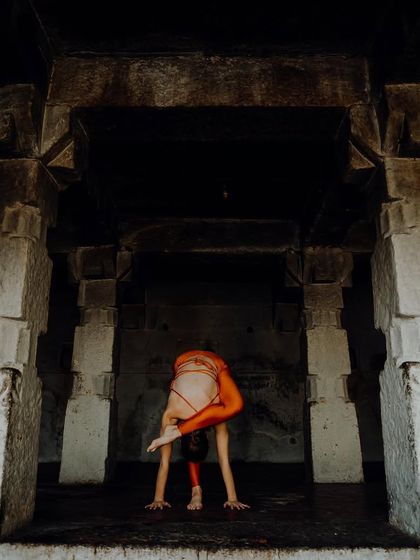 A variation of Eka Pada Koundinyasana in a temple in Hampi. Advanced poses are a process of discovery, requiring an open mind to explore new possibilities and expand your limits.
