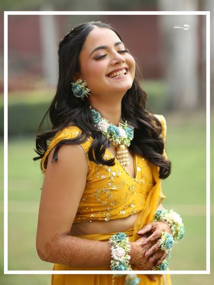 A radiant, happy portrait of the bride. Her genuine, uninhibited laughter is the centerpiece of this beautiful shot from her Haldi ceremony.