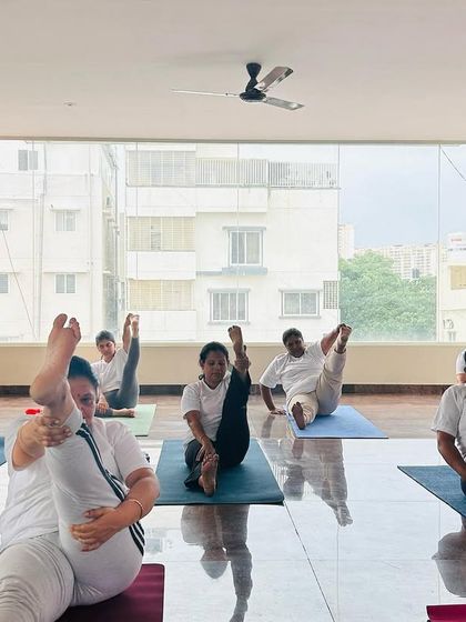 This image shows the dedication of our students as they practice Utthita Hasta Padangusthasana, or Extended Hand-to-Big-Toe Pose. It's a challenging balance that improves focus and leg flexibility.