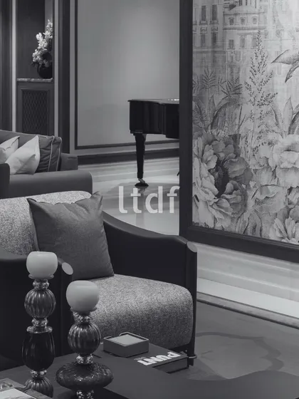 An atmosphere of understated elegance, where each detail from the plush seating to the exquisite floral wallpaper creates a serene and inviting living space. This room blends classic refinement with modern comfort, making it a perfect retreat within the home.
