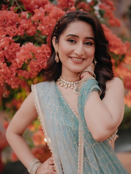 A happy, close-up portrait of the bride, her genuine smile and sparkling eyes lighting up the frame.