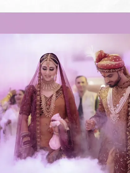 The couple makes their entrance, walking through a cloud of smoke, which adds a dreamy and dramatic effect to their wedding photos.