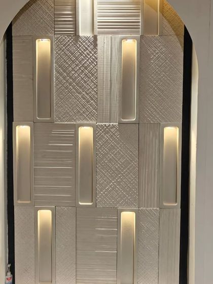 This stunning wall cladding combines textured panels with integrated, concealed lighting. The result is a sophisticated feature that provides both visual interest and ambient light.