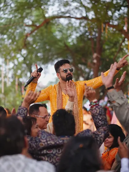 The energy you give is the energy you get! Leading the crowd in a cheer during a high-spirited Haldi event.
