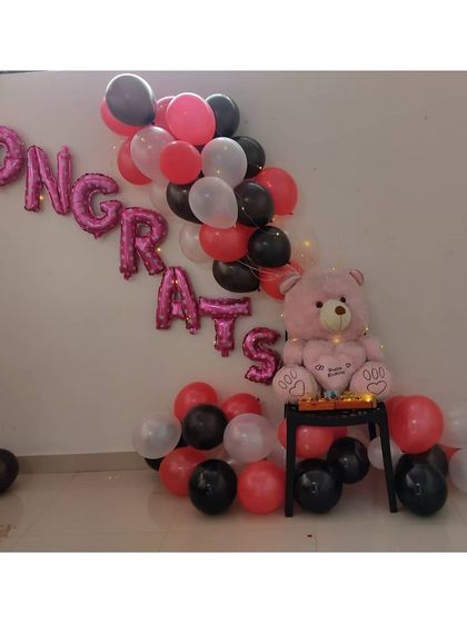 This image shows the 'Congrats' setup with a small tray of sweets placed next to the teddy bear, adding a personal touch to the celebration.