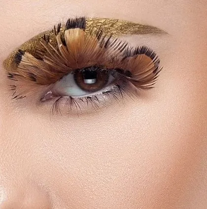 An extreme close-up of the eye with gold and feather makeup. This shot demonstrates my ability to capture minute details with precision, essential for cosmetic and beauty campaigns.