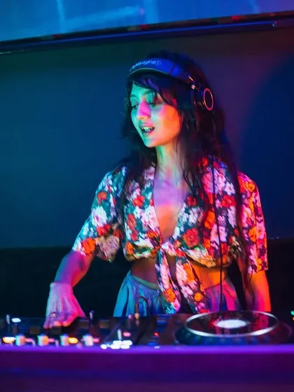 In the zone, with a floral top adding a pop of color to the dark club. I love expressing my personality through my style, even at work.