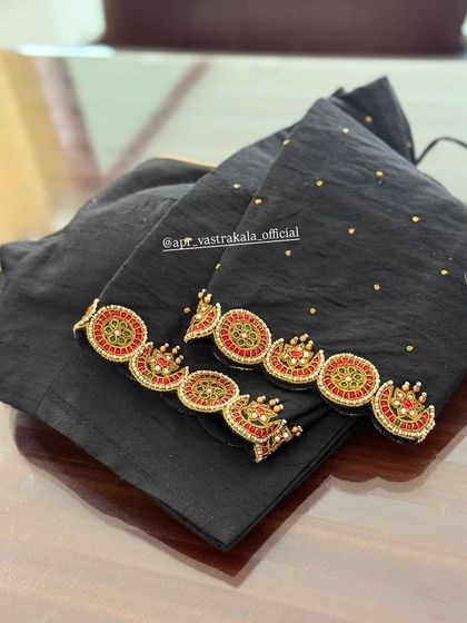 The full view of the black blouse with kemp stone work.