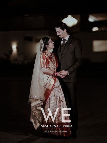 A full-length portrait of the couple at their night time reception. This shot showcases their complete outfits and their happy, relaxed posture.