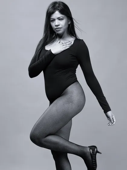 A full-body monochrome portrait in a classic pose. This black and white image highlights the model's form and posture, ideal for a dance or fashion portfolio.
