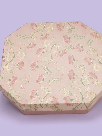 An octagonal gift box with a delicate floral pattern. We shoot from an angle that best represents the unique shape of the product.
