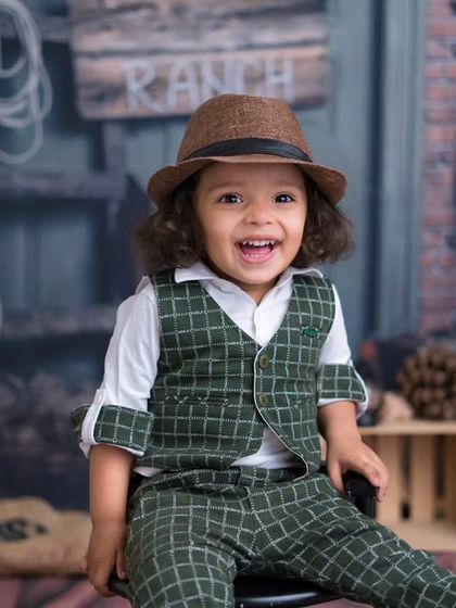 The happiest little cowboy on the ranch. This two-year-old's joyful smile lights up this rustic, western-themed birthday shoot.