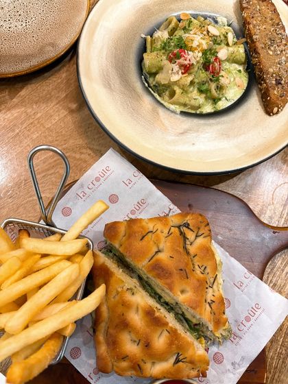 This spread at La Croûte shows the variety they offer, from sandwiches and pasta to classic fries. I compose my shots to give a comprehensive view of the menu, helping potential customers see the breadth of options.