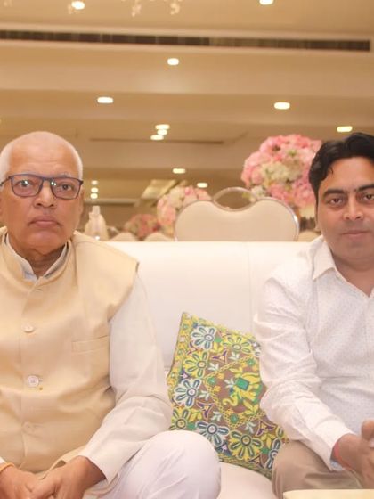 Two men sitting together for a portrait at a formal event. We capture both formal and informal moments throughout your gathering.