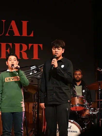 Three of our vocal students leading the band with confidence. Our vocal training includes microphone techniques and stage presence to prepare singers for live gigs.