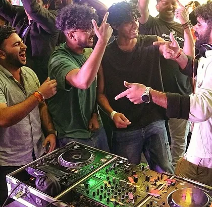 I'm not a DJ who hides in the corner. This shot from the Under 25 Summit captures how I get right into the crowd, hyping everyone up and making the party an interactive experience for everyone involved.