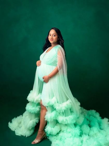 A simple and elegant portrait in our mint green ruffled gown, showcasing its beautiful color and flowing silhouette.