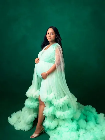 A simple and elegant portrait in our mint green ruffled gown, showcasing its beautiful color and flowing silhouette.