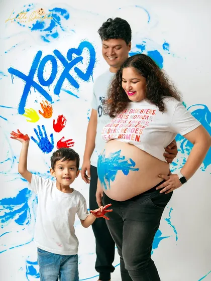 The grand finale of a fun and messy paint session to celebrate a pregnancy! The whole family got involved in creating this unique and colorful memory.