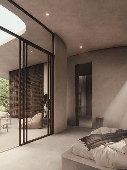 A bedroom in the House of Veils, where filtered light from screened walls and courtyards creates a soft, tranquil atmosphere. The space opens onto a private terrace, extending the living area into the outdoors.