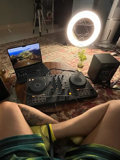 The behind the scenes of my living room studio. You can see my DJ console, laptop, speakers, and the ring light I use to film these sessions.