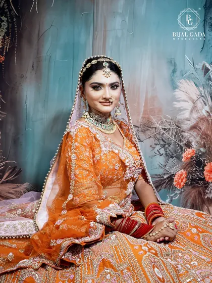 Another beautiful shot of the bride in her orange attire. Her happy expression and the intricate details of her jewelry and makeup are captured perfectly here.
