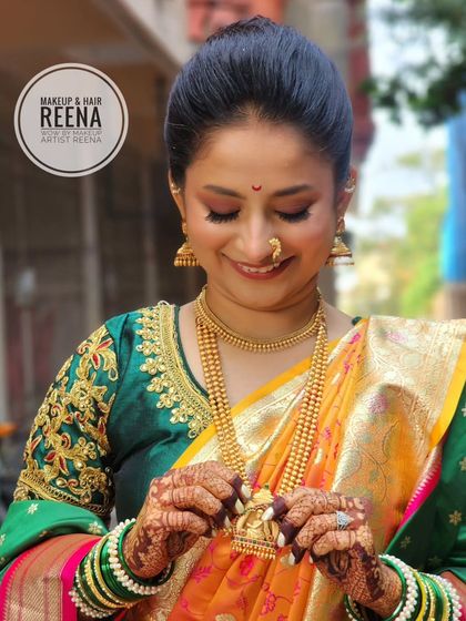 A candid moment with Aditi, admiring her beautiful bridal jewellery. The soft, glowing makeup enhances her natural beauty.