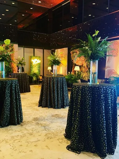 Cocktail tables were draped in black leopard-print cloths, a subtle but effective detail that reinforced the jungle glam theme throughout the event space.