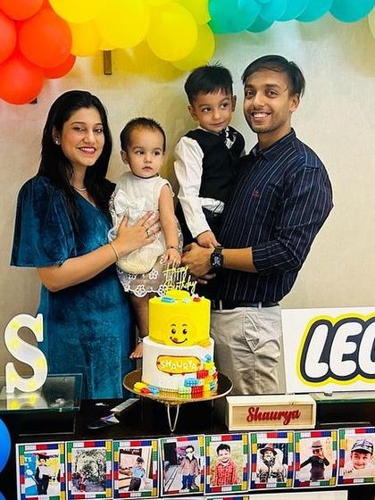 A happy family celebrating with a fun Lego-themed cake. It's a joy to see my creations be part of such special family moments.