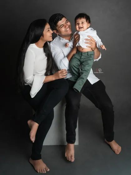 So much joy in one photo. The baby's big smile makes this family portrait even more special and full of life.