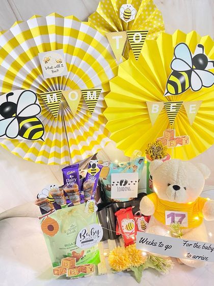 A jumbo 'Mommy to Bee' hamper with a fun bee theme. This gift is buzzing with snacks, a teddy bear, and cute decorations to celebrate the expectant mother.