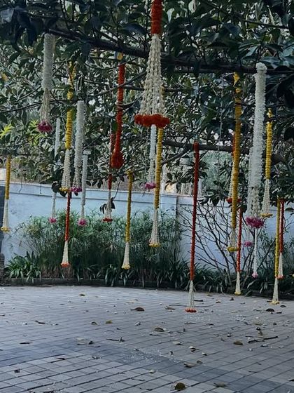 This image shows the entrance area with the hanging floral decorations on the tree and a welcome sign in the background. It demonstrates how we tie different decorative elements together for a cohesive look.