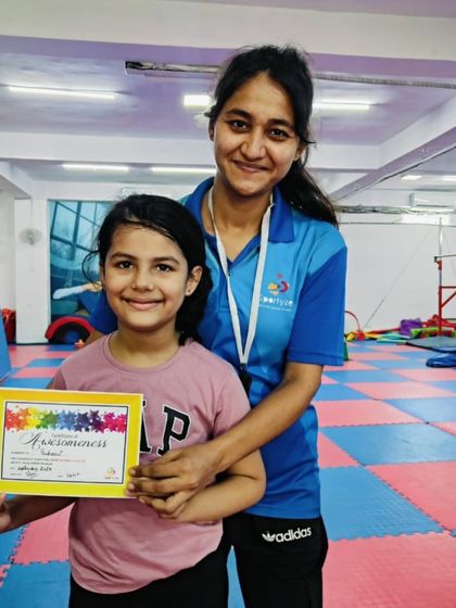 This happy student shows off her "Awesomeness" certificate.