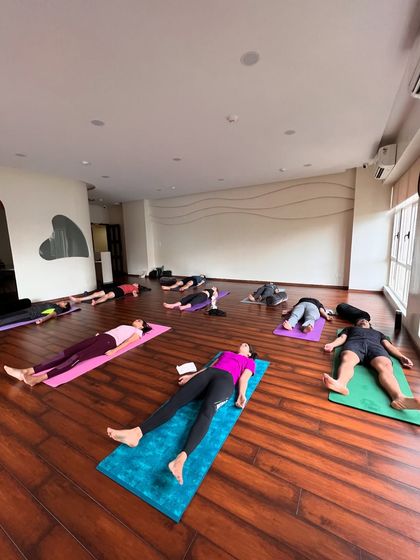 A full studio resting in Savasana. This is our shared moment of peace and surrender.