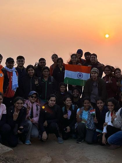 A proud Republic Day group photo with the Indian flag after our sunrise trek to Huthridurga.