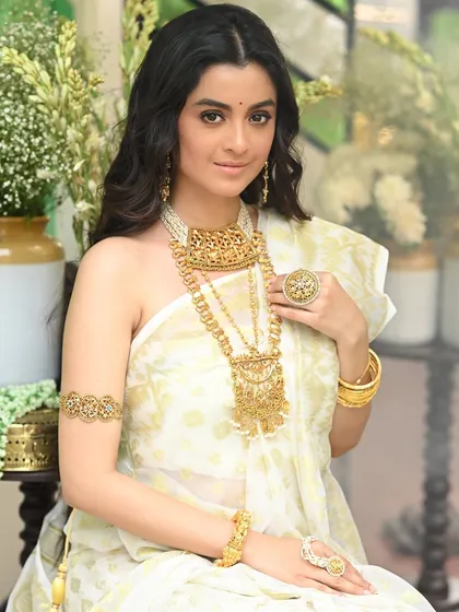 A beautiful portrait of actress Darshana Banik from her Sananda magazine shoot. The composition is clean and elegant, focusing on her and the exquisite gold jewellery.